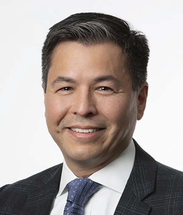 Headshot photograph of Ethan Schutt smiling