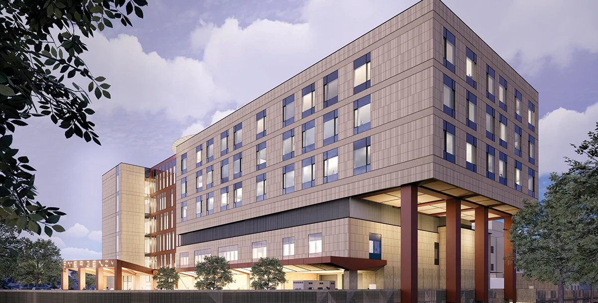 Architectural rendering of the new Providence Alaska Medical Center emergency department expansion, featuring a modern multi-story design with tan cladding and dark window accents