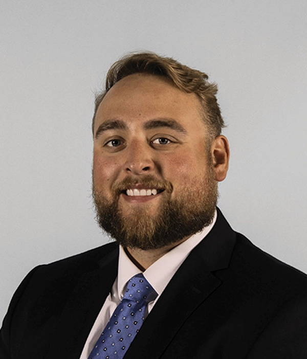 Headshot photograph of Evan Wilken smiling