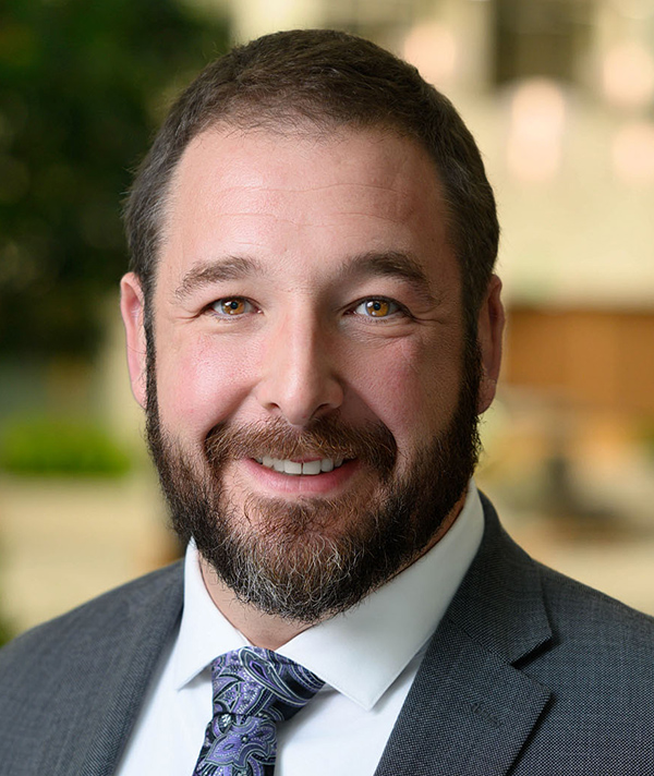 Headshot photograph of Jed Ullrich smiling