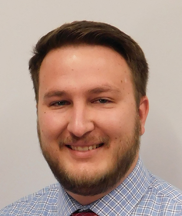 Headshot photograph of Tyler VanAusdal smiling