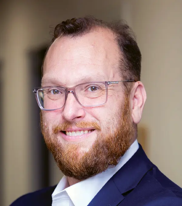 Headshot photograph of Jon Bittner smiling