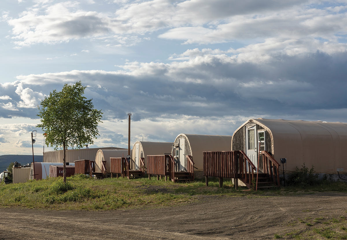 A row of modular housing units with wooden porches