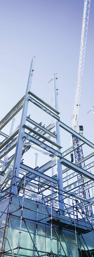 Steel framing and scaffolding at an active construction site.