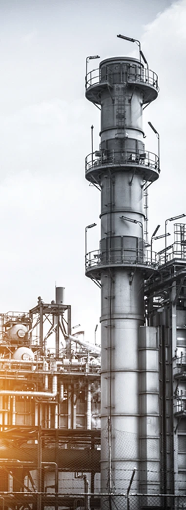 Industrial processing tower and equipment at an oil and gas facility.