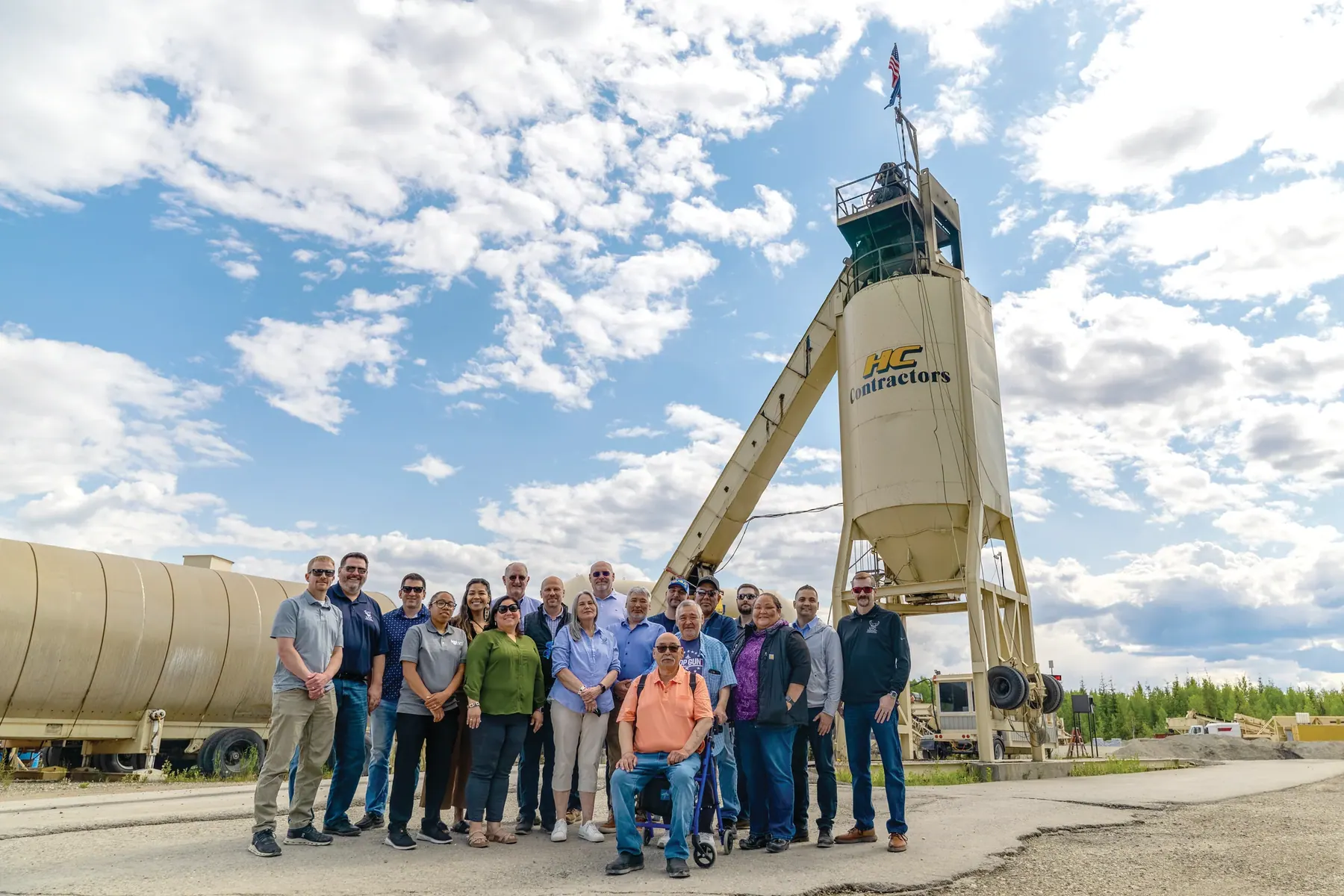 Members of Ukpeaġvik Iñupiat Corporation’s board of directors, executive leadership, and staff pose in front of the HC Contractors asphalt plant in North Pole during a site visit to subsidiaries HC Contractors and HC Redi-Mix.