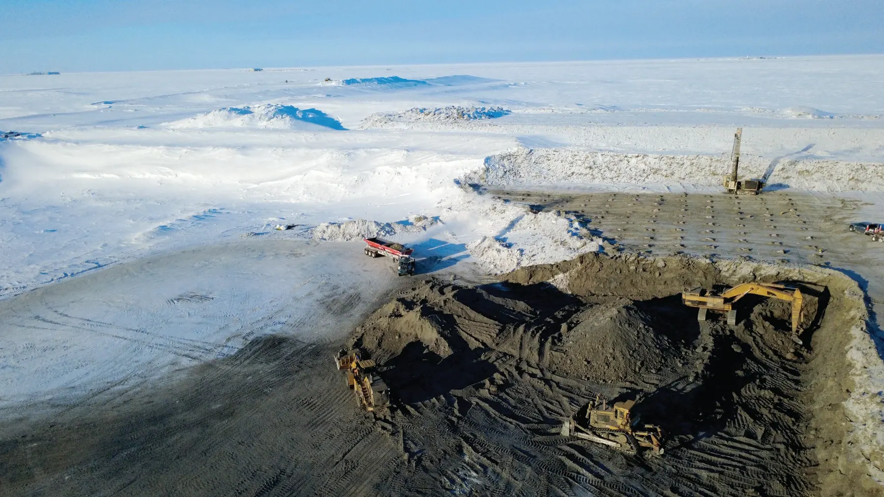 Cruz Construction employees mine gravel near Oliktok Point to build the first new drill pad in the Prudhoe Bay unit this century.