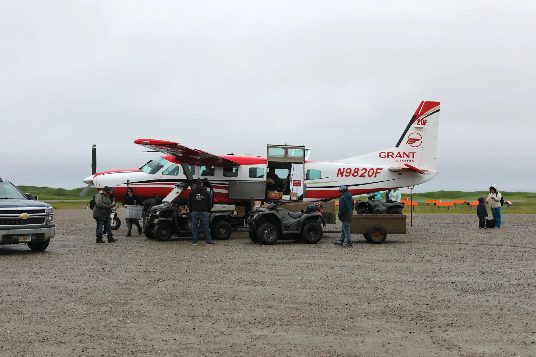 Grant Aviation team members unload passengers and cargo from a flight, helping connect the people and communities they serve across rural Alaska.